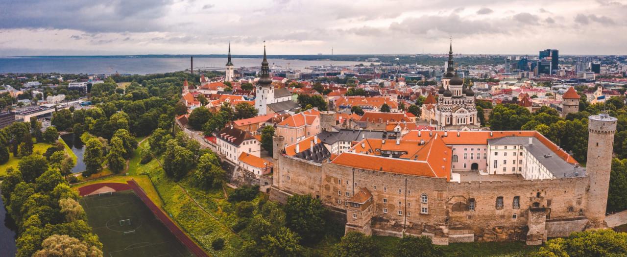 aerial shot old town tallinn with orange roofs churches spires narrow streets